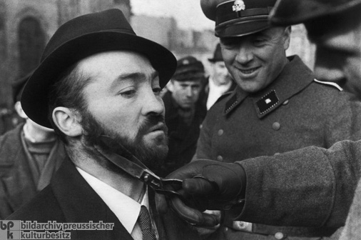 A Member of the SD Cuts the Beard of a Warsaw Jew (October 1939)